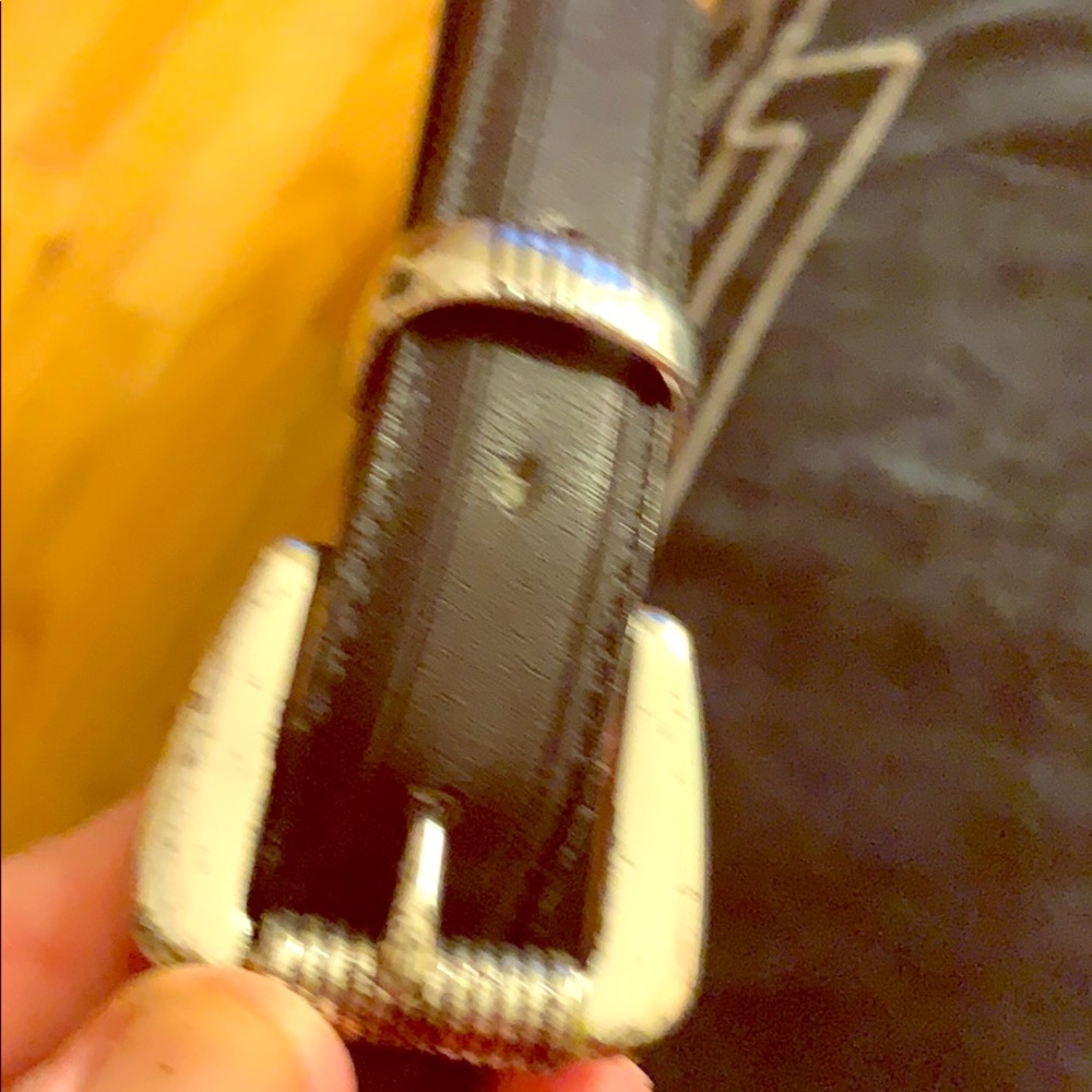 One men’s black leather belt with silver hardware